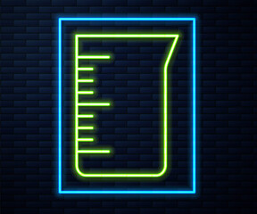 Glowing neon line Laboratory glassware or beaker icon isolated on brick wall background. Vector