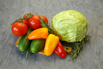 Still life of vegetables for healthy eating on a gray background.