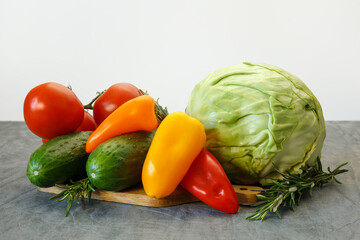 Still life of vegetables for healthy eating on a gray background.