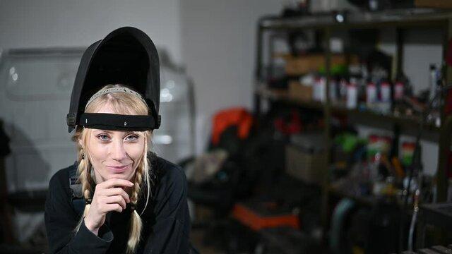 Video of a woman welder working in a mask in the industry