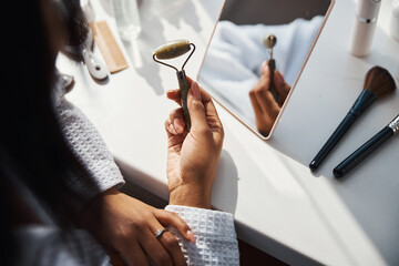 Female hands holding natural stone massage roller