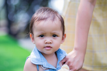 Happy mother and daughter walking in the garden