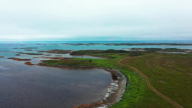 Aerial view overlooking the coast of cloudy Andoya island - rising, drone shot