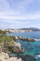 View of greenish crystalline waters in front of the town of CALELLA DE PALAFRUGELL