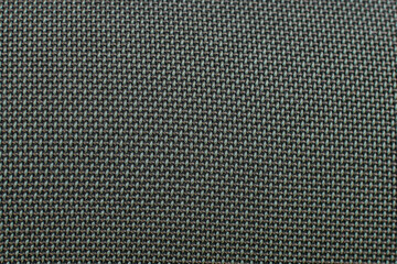 Close-up of dark green speaker surface texture. Macro. Woven mesh surface. metal grille, mesh...