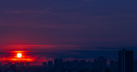 The high angle background of the city view with the secret light of the evening, blurring of night lights, showing the distribution of condominiums, dense homes in the capital community