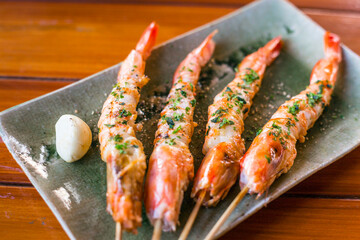 Japanese shrimp grill or yakitori serve in izakaya style restourant set on Japanese style