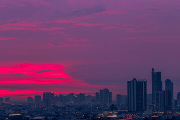 The high angle background of the city view with the secret light of the evening, blurring of night lights, showing the distribution of condominiums, dense homes in the capital community