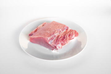 sliced raw pork meat isolated on white background ready for cooking. a piece of pork