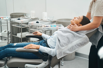 Obraz na płótnie Canvas Tranquil female patient getting a neck massage