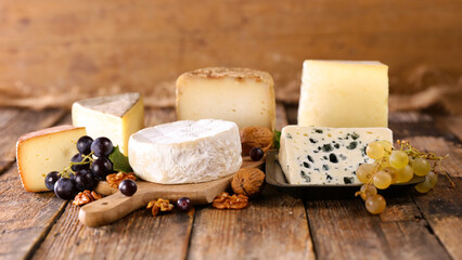 selection of french cheese on wood background