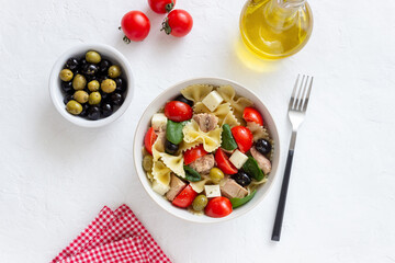 Pasta salad with tuna, tomatoes and white cheese. Farfalle. Healthy eating. Diet.