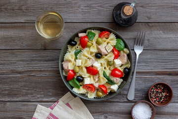 Pasta salad with tuna, tomatoes and white cheese. Farfalle. Healthy eating. Diet.