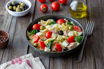 Pasta salad with tuna, tomatoes and white cheese. Farfalle. Healthy eating. Diet.