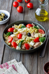 Pasta salad with tuna, tomatoes and white cheese. Farfalle. Healthy eating. Diet.