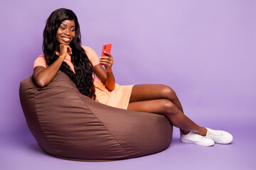 Full size photo of brunette nice afro american girl sit chair look phone think wear summer outfit...