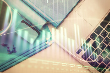 Double exposure of forex graph drawing over desktop background with computer. Concept of financial analysis. Top view.