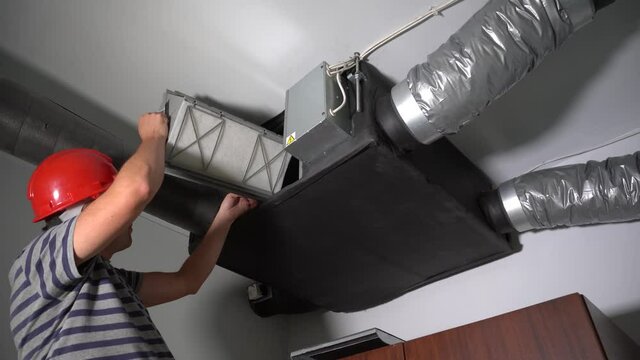 Professional Guy Install Filter for Home Central Air Recuperation System