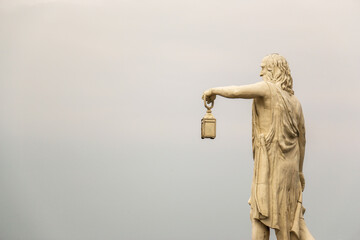 Famous ancient Greek philosopher Diogenes sculpture, holding light born in Sinop in the 5th century BC., with cloud backround.
