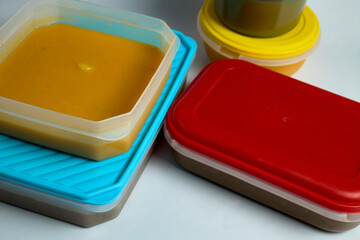 Plastic lunch box with lentil stew and pumpkin puree 