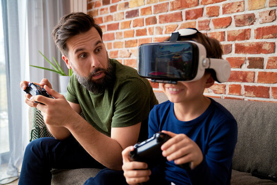 Surprised father playing video game with his son