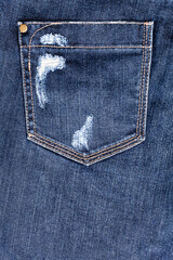 Blue worn jeans pocket close up, ripped jeans pocket background, dark blue damaged denim backdrop,...
