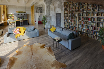 Dark loft style interior of big cozy country house. open plan apartment with kitchen area, rest...