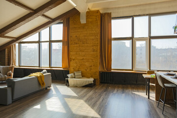 Dark loft style interior of big cozy country house. open plan apartment with kitchen area, rest...