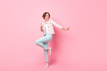 Full size photo of young pretty happy excited crazy smiling girl dancing enjoying weekend isolated on pink color background