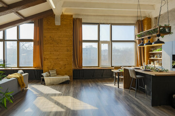 Dark loft style interior of big cozy country house. open plan apartment with kitchen area, rest...