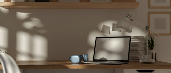 3D rendering, portable workspace with laptop, headphone, cup, lamp, stack of books and copy space on wooden desk