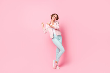 Fototapeta na wymiar Full size photo of dreamy happy brunette woman dance funky smile isolated onn pastel pink color background