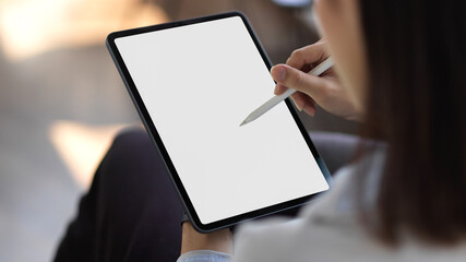 Cropped shot of young female holding mock up blank screen digital tablet
