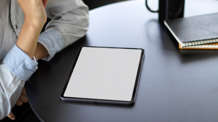Close up view of young female using mock up blank screen digital tablet