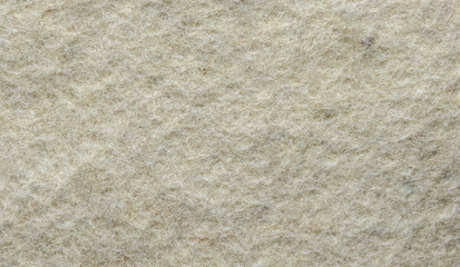 Felt fabric background. Self-colored, undyed felt texture, macro shot.
