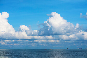 Obraz premium pure clear blue sky huge white gray cloud and sunlight shiny on tropical on the sea and fishing boat