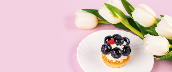 Banner. Mignon cake and Tulip bouquet. Selective focus. Copy space.