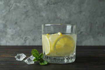 Glass of lemonade on wooden table, close up