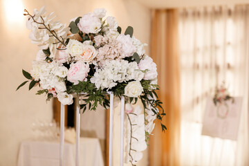 Festive Floral decor on wedding banquet tables in white colors with cutlery