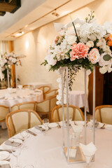Festive Floral decor on wedding banquet tables in white colors with cutlery