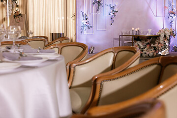 Festive Floral decor on wedding banquet tables in white colors with cutlery