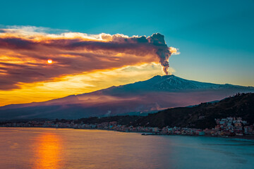 Epic eruption of Mt Etna during sunset. Volcanic eruption by the sea