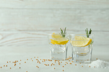 Shots of tequila on white textured table