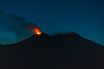 Fire and lava flowing on the top  of mount Etna during eruption. Night scenery 