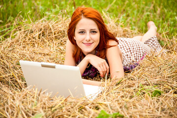 Young  fashion girl with notebook lying at field