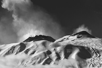 Black and white image of a snow covered crater of Mount Etna - the highest active volcano in Europe 
