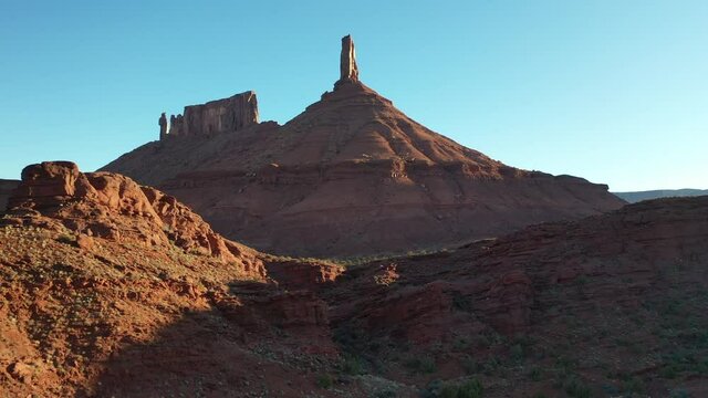 Aerial video of Castleton Tower rock formation in Utah. Drone footage flying backwards with tilt up.