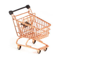 Empty miniature Copper shopping cart isolated on white. Close-up shot, side view. stock photo