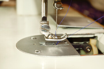 close-up - the open cover of the sewing machine for replacing the thread spool