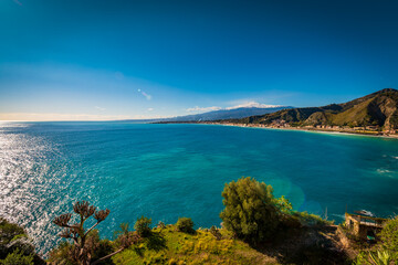 Turquoise sea and Mount Etna on the Mediterranean coast of Taormina, Sicily 